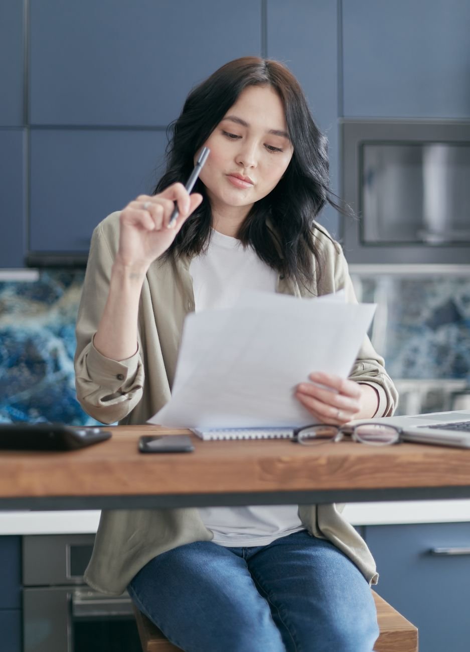 Maria, a restaurant owner reviewing her business documents.