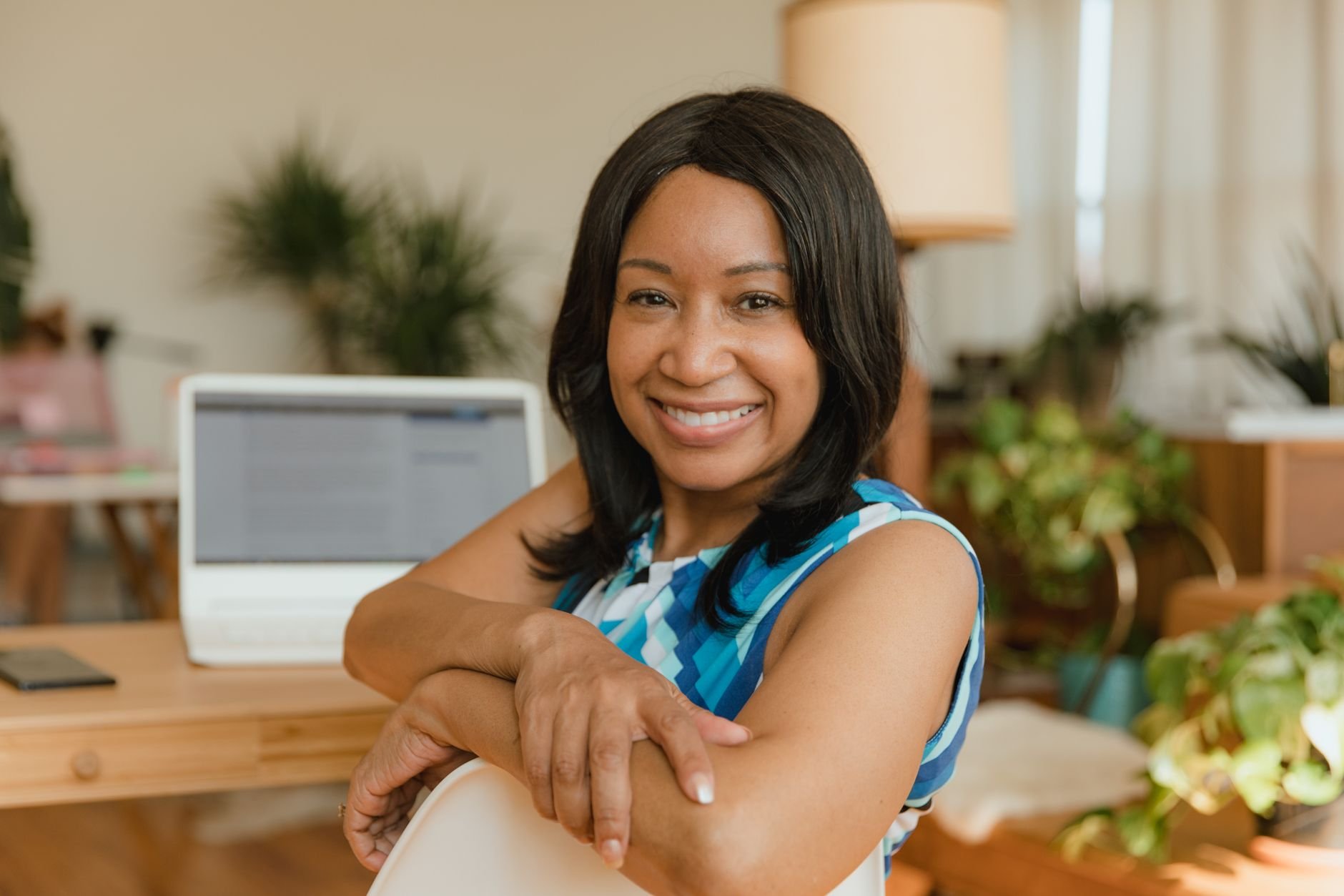 A confident business owner at her desk, ready to grow her business.